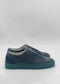A pair of ML0141 Black W/ Green sneakers, handcrafted in Portugal from premium Italian leathers, viewed from the side against a plain white background.