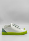 The ML0142 White W/ Yellow sneakers, handcrafted in Portugal from premium Italian leathers, feature neon green soles and a light green heel accent against a plain gray background.
