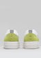 Rear view of two V22 Pastel Green & Lime low top sneakers with gray pull tabs, displayed against a neutral gray background.