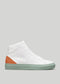 A white leather high-top sneaker with a V36 Pastel Green W/ Orange heel cap and a pale green outsole, displayed against a grey background.