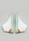 A pair of white leather wedge sandals with V36 Pastel Green W/ Orange straps and brown soles against a gray background.