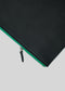 Una M leather pouch black w/green con cremallera verde azulado, parcialmente abierta, aislada sobre fondo blanco.
