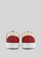 The back view of the M0024 by Rodrigo sneakers displays a retro-future style in striking red and white with premium Italian leathers and a beige collar, set against a plain gray background.