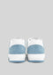 Rear view of a pair of M0002 by Sara Q blue and white low top sneakers against a grey background.