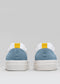 Vista trasera de dos V11 White & Artic Blue low top sneakers con lengüetas amarillas sobre fondo gris.