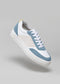 A stylish sneaker with a V11 White & Artic Blue panels, a white lace-up front, and a thick white sole, displayed against a neutral gray background. These are vegan shoes designed for both comfort and style.