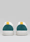 Rear view of two V8 White & Emerald Green low top sneakers with dark green accents and yellow tabs on a gray background.