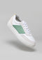 A V12 White & Pastel sneaker with a green suede panel and a yellow detail on the heel, displayed against a light gray background.