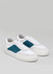 A pair of V9 White & Petrol Blue shoes with blue suede panels and thick soles, displayed on a neutral gray background.