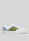 A side view of a V13 White & Pine low top sneaker with a white body, featuring a green center panel and a light blue heel, on a grey background.