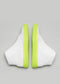 A pair of V15 White Leather w/ Yellow wedge sneakers with neon green accents and zipper closures, viewed from the rear on a gray background.
