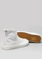 A pair of Twist High White Canvas for men with a brown rubber sole, displayed on a light gray background.