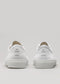 A pair of Twist Low White Canvas sneakers facing forward with a plain design and thick soles, displayed against a light gray background.