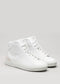 Un par de V8 White Leather w/Bone custom high-top sneakers con cordones sobre fondo gris claro.