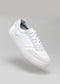 white synthetic leather sneakers in contemporary design floating sideview