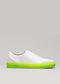 White slip-on sneaker with a SO0001 JL Fluo-Corra sole on a gray background.