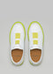 Top view of a pair of SO0001 JL Fluo-Corra sneakers with neon yellow accents and brown insoles, displayed on a gray background.