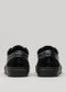 cuero negro premium bajo par de sneakers en diseño limpio backview