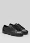 cuero negro premium bajo sneakers en diseño limpio vista frontal