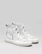 A pair of MADE by proxy 5/5 white canvas high-top sneakers on a gray background.