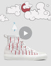 Illustration of a A Blissful Death 4/5 high-top canvas sneaker with red anchor patterns on a white background, next to a play button overlay and doodles of clouds and a bird.